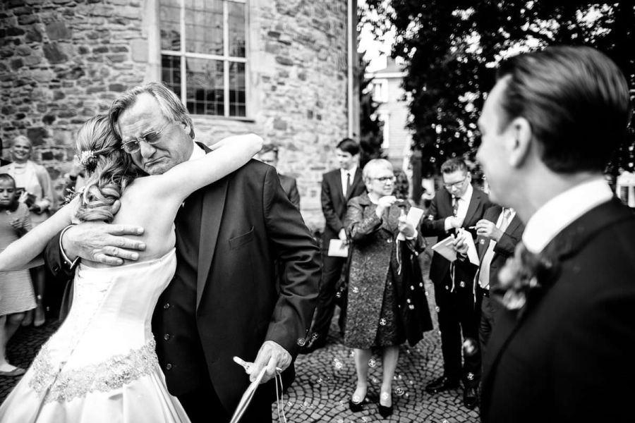 Stimmungsvolles Hochzeitsfoto vom Anziehen des Hochzeitskleids