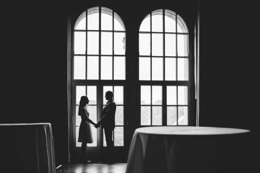 Brautpaar als Silhouette vor den großen Fenstern im Neuen Rathaus Hannover
