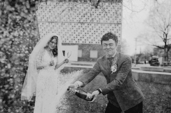 Brautpaar öffnet eine Sektflasche nach der Hochzeit in Hannover